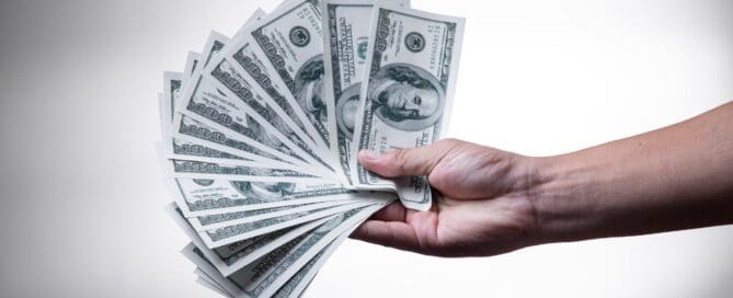 hand holding money fanned out