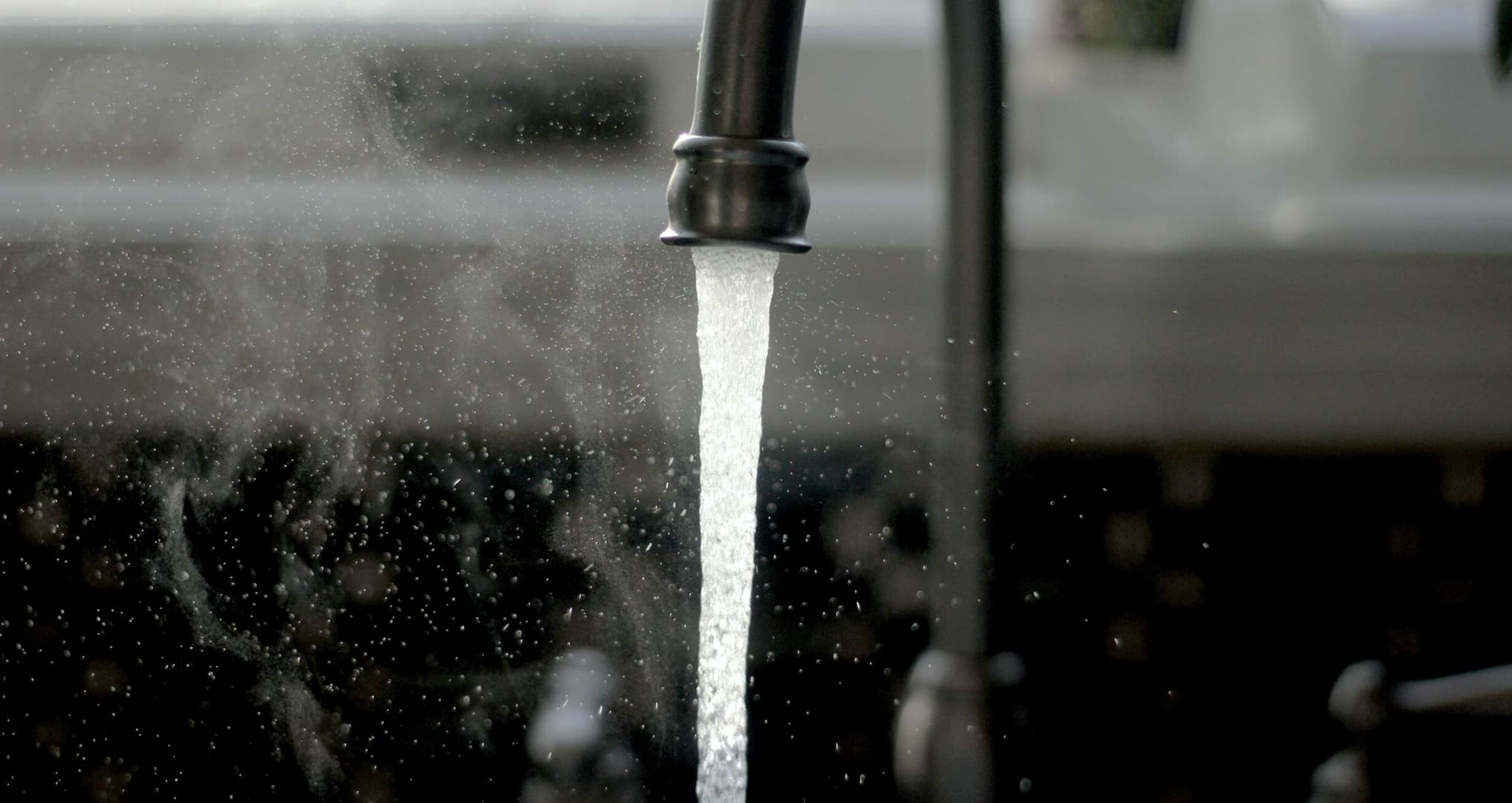 faucet running in kitchen