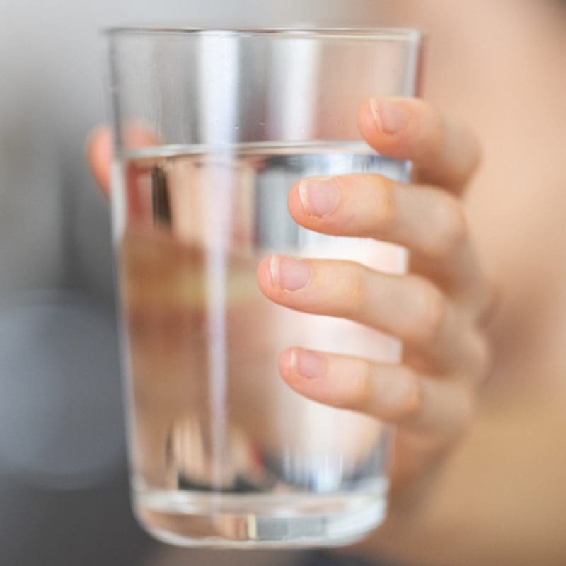 woman holding a glass of water Preparing for a water chemical disaster
