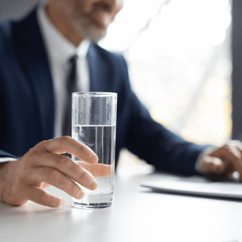 employee reaching for glass of water employee reaching for glass of water