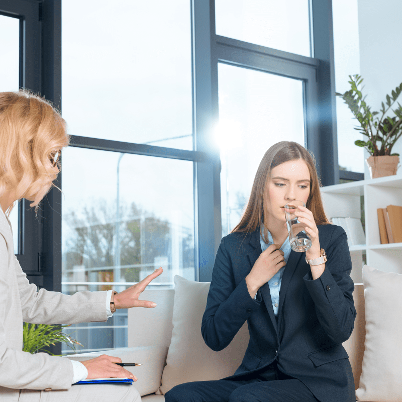manager offering employee a drink of water manager offering employee a drink of water
