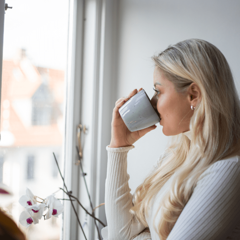 woman sips tea at work