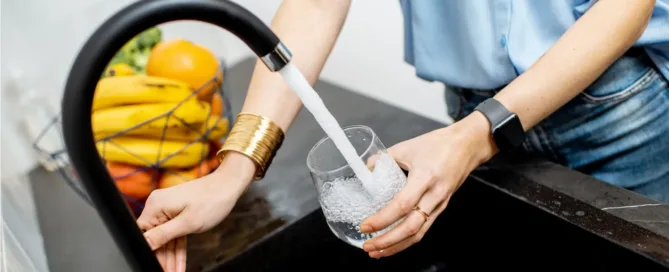 Woman refilling cup with RO water