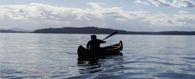 native-american-canoe-paddling-out-to-distant