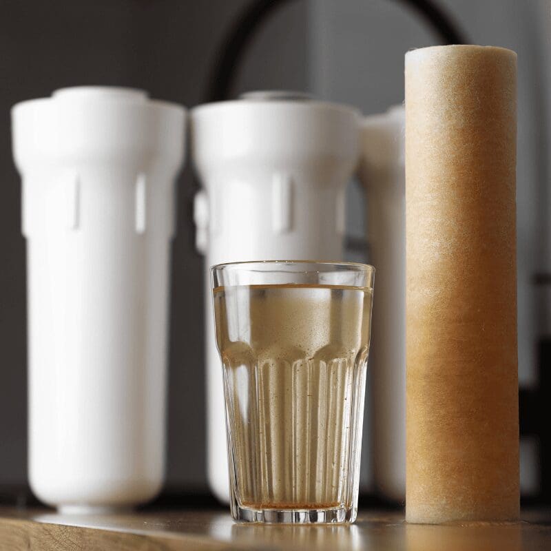 water filter cartridge and dirty glass of water
