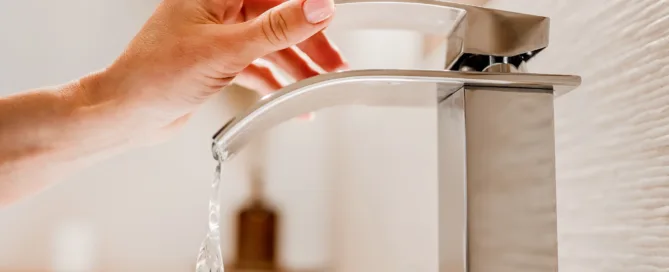 woman-turning-on-faucet
