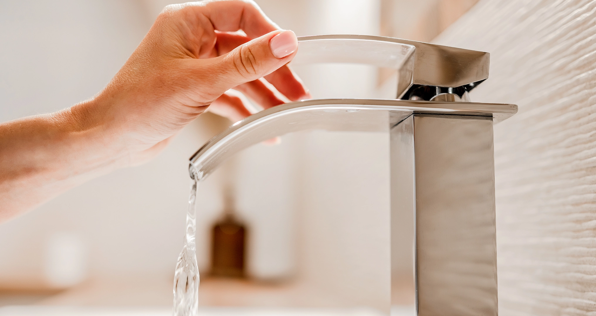 woman-turning-on-faucet