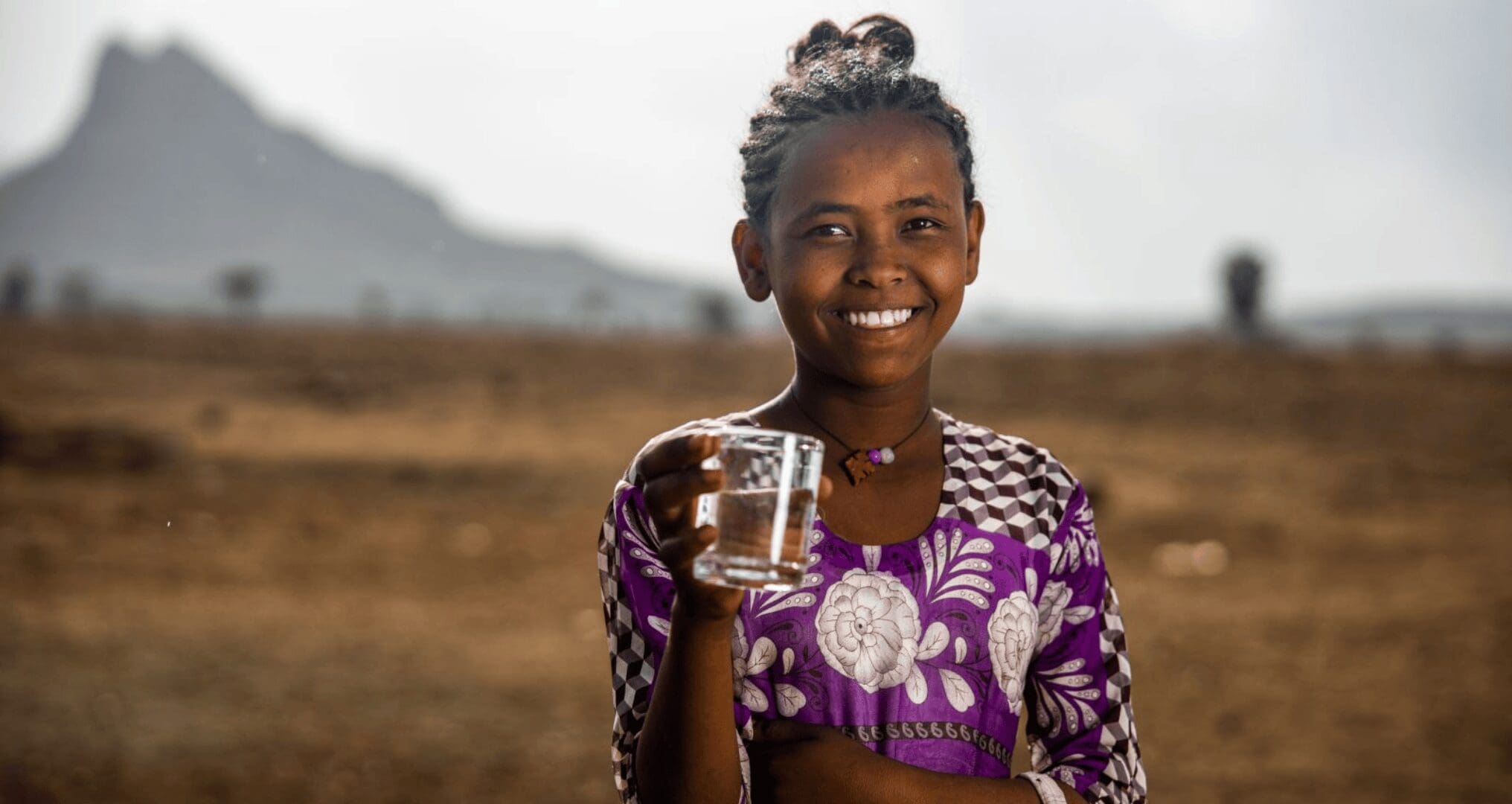 african kid holding a glass of water kid holding a glass of clean drinking water