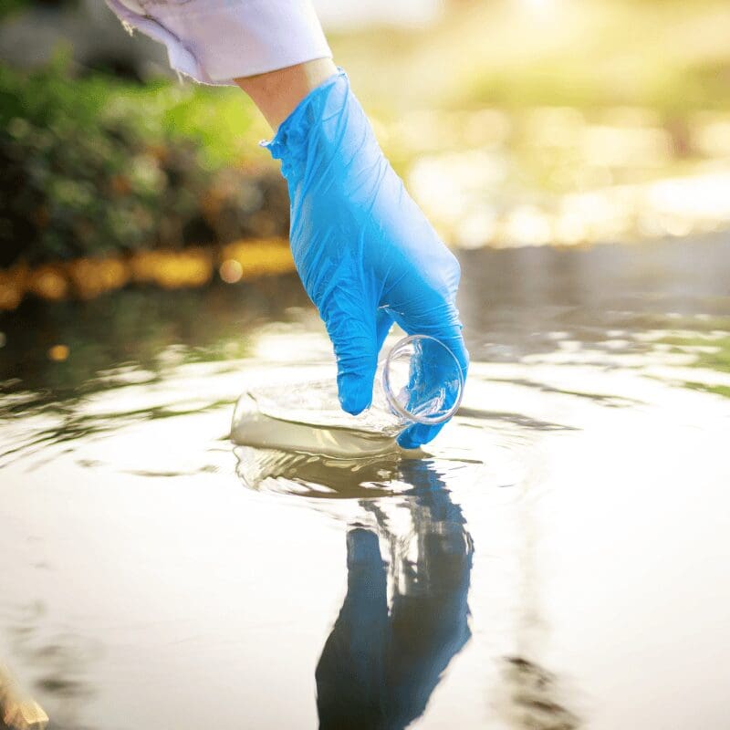 scientist testing river water for pollution