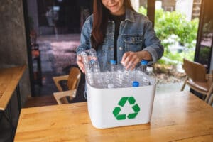 A beautiful asian woman collecting and separating recyclable gar
