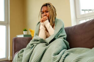 woman at home feeling ill