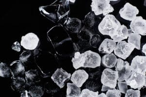 top view of fresh frozen ice cubes isolated on black view of clean ice from ice machine