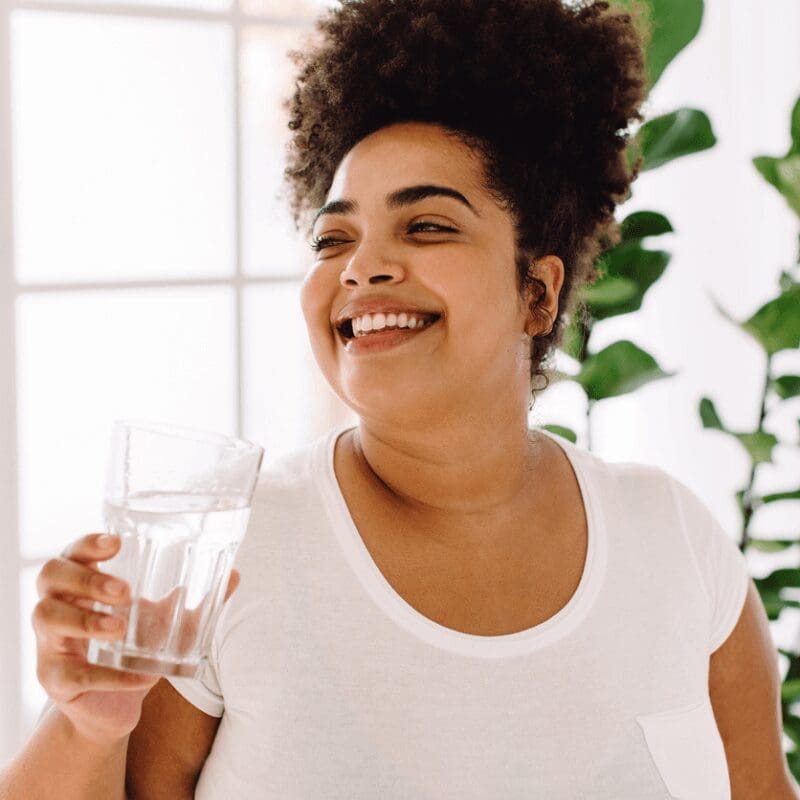 african-american woman at the office holding a glass of water african-american woman at the office holding a glass of water