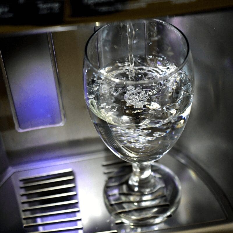 filling-up-a-glass-goblet-in-a-refrigerator-door glass getting filled with water under spout