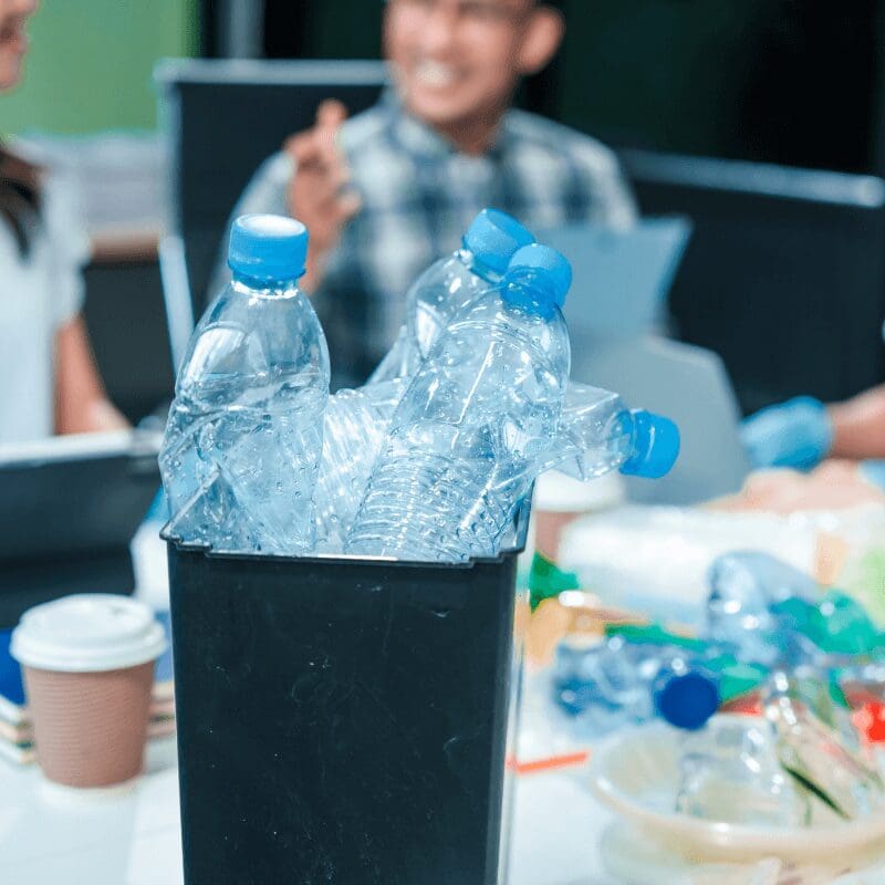 asian-team-discusses-waste-management-strategies team meeting about plastic reduction in the office