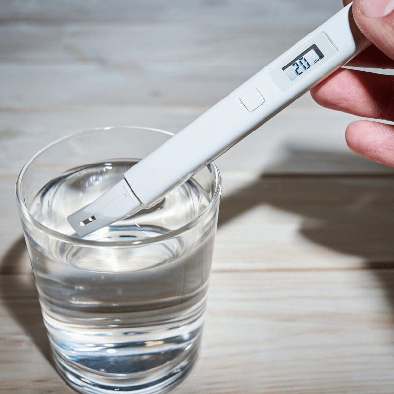 a-researcher-uses-a-electric-water-tester a researcher using a TDS instrument